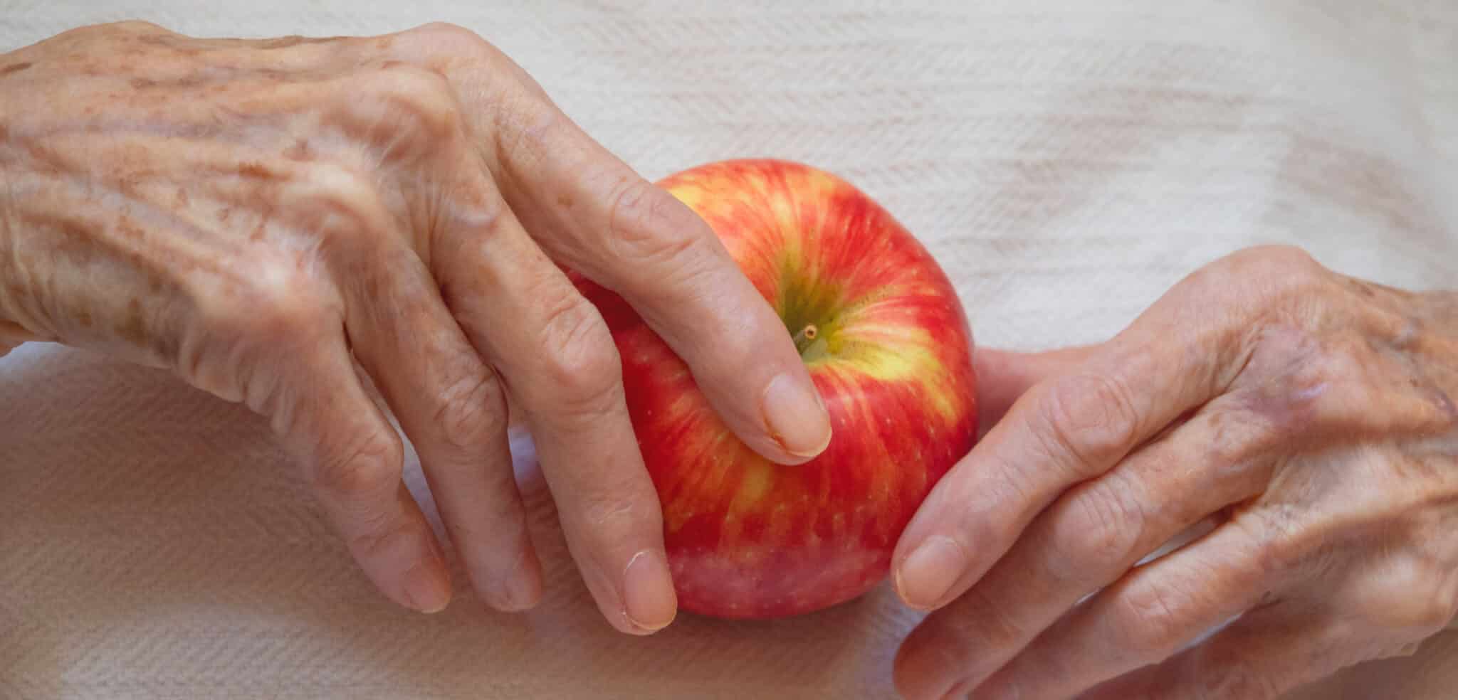 Elderly Woman Holding an Apple Photographed from Above