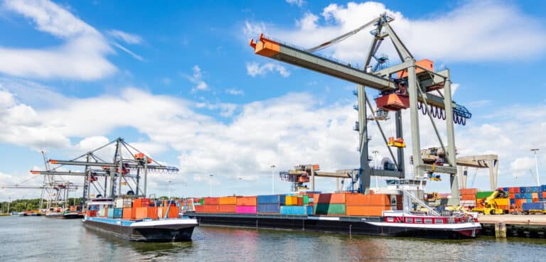 Container ship and logistics. Crane loading a container ship at
